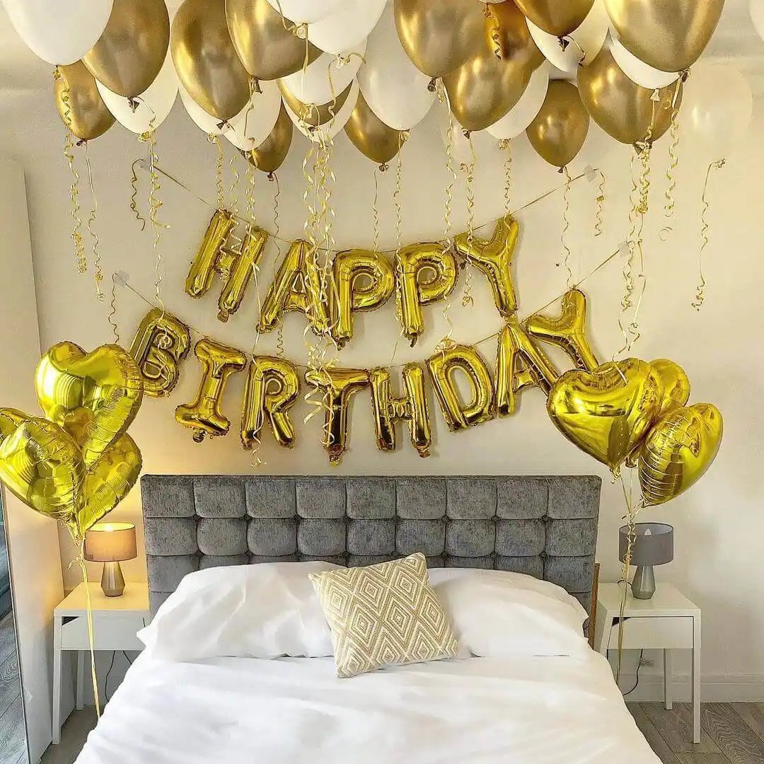 Festive bed setup with balloons and birthday decorations