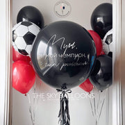 Balloon in black and red colors soccer ball with text.