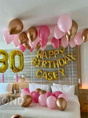 Festive bed with colorful balloons and a birthday sign, perfect for a birthday surprise