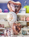 A colorful assortment of balloons and various items on display in a store.