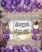 Purple balloon bouquet with bride and groom balloons, perfect for wedding celebrations.