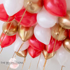 Red, gold, and white balloons with gold foil, creating a festive and elegant atmosphere.